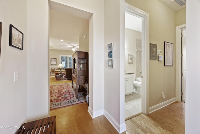 hallway with light hardwood / wood-style flooring