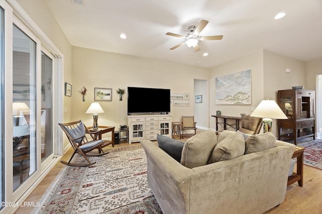 living room featuring ceiling fan and light wood-type flooring