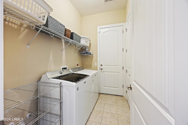 laundry room with light tile patterned floors and independent washer and dryer