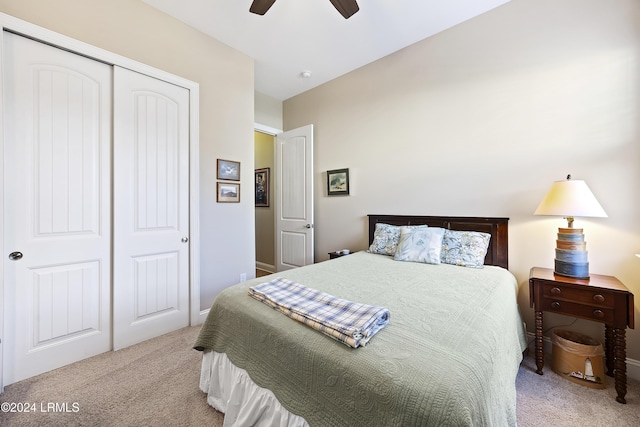 carpeted bedroom with ceiling fan and a closet