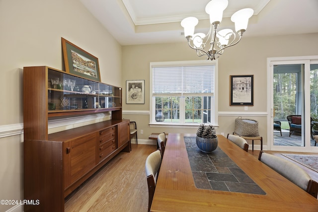 dining area with an inviting chandelier and light hardwood / wood-style floors