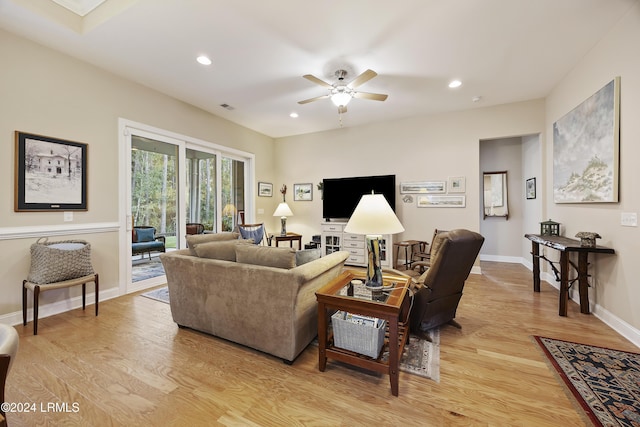 living room featuring ceiling fan and light hardwood / wood-style flooring