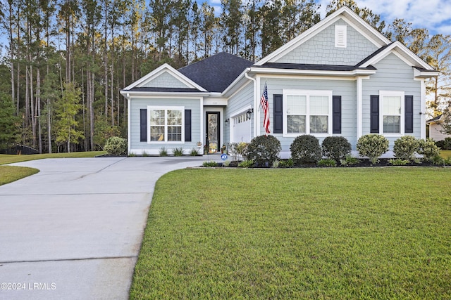 view of front of property featuring a garage and a front lawn