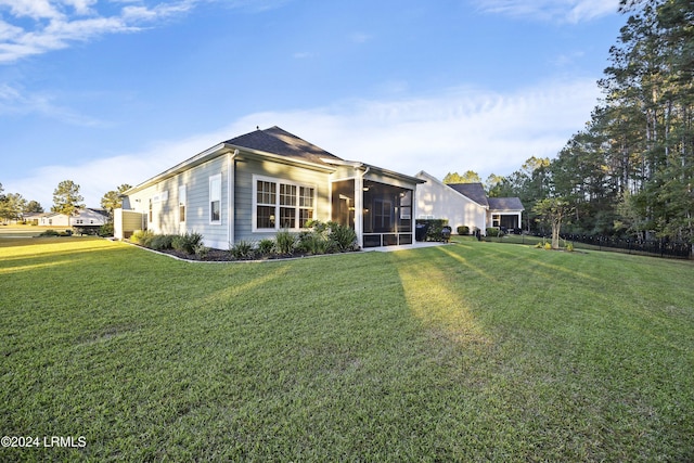 view of front of house with a sunroom and a front yard