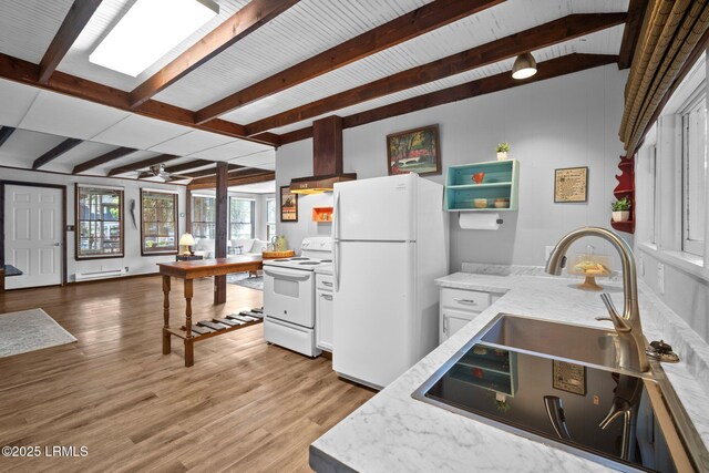 20 Trout St, Bluffton, SC 29910 - kitchen with white appliances, beamed ceiling, white cabinets, a sink, and light wood-style flooring