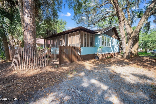 20 Trout St, Bluffton, SC 29910 - view of side of home featuring fence and a sunroom
