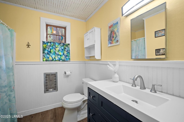 20 Trout St, Bluffton, SC 29910 - bathroom featuring crown molding, toilet, a wainscoted wall, heating unit, and wood finished floors