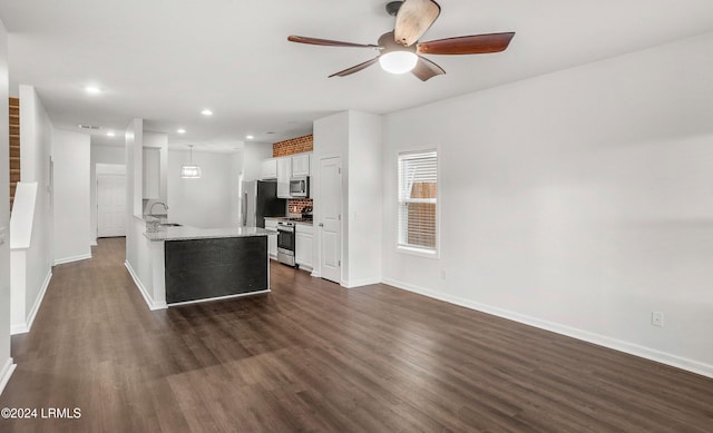 kitchen with tasteful backsplash, stainless steel appliances, dark hardwood / wood-style floors, and white cabinets