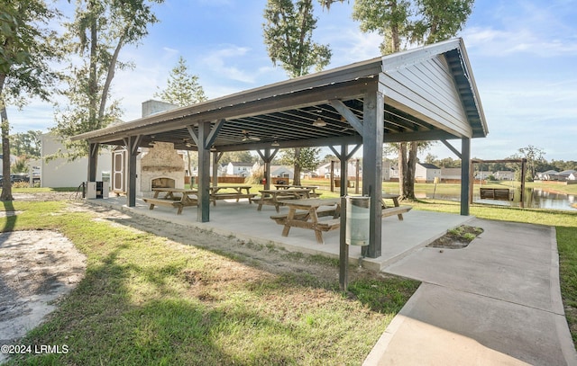 surrounding community with a gazebo, a lawn, a patio, and a water view