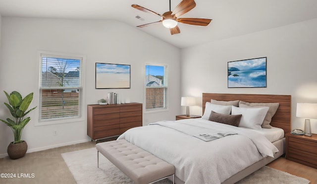 bedroom with vaulted ceiling, light carpet, and ceiling fan