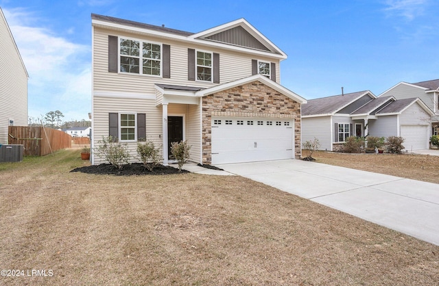 view of front of home with central AC unit, a garage, and a front lawn