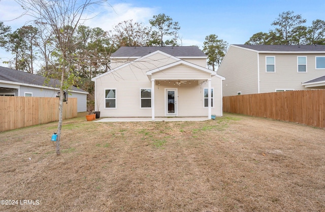 rear view of house featuring a yard and a patio area