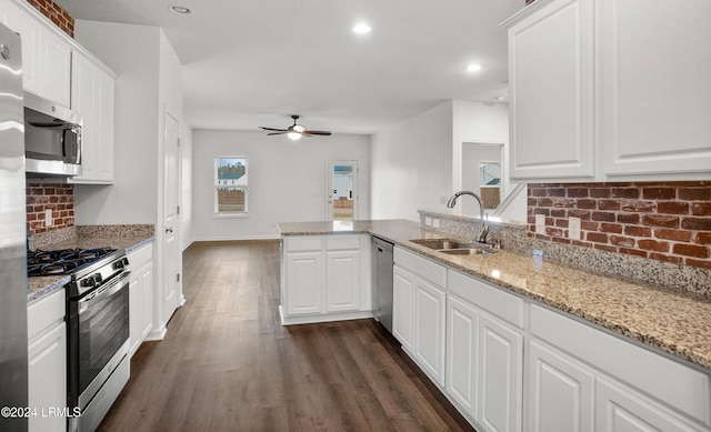 kitchen featuring stainless steel appliances, sink, white cabinets, and kitchen peninsula