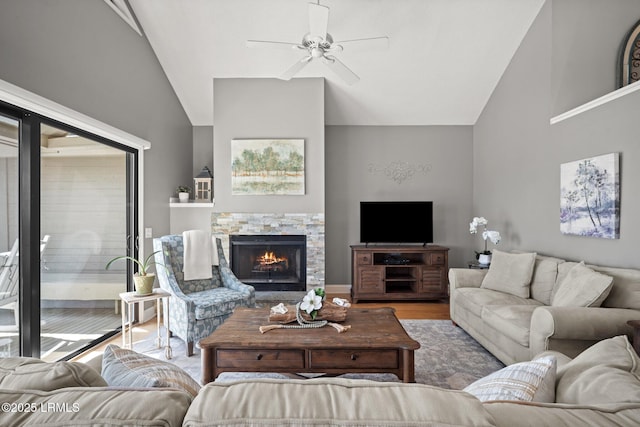 2009 Bluff Villas Rd, Saint Helena Island, SC 29920 - living room with vaulted ceiling, ceiling fan, a stone fireplace, and wood finished floors