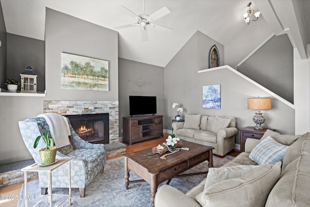 2009 Bluff Villas Rd, Saint Helena Island, SC 29920 - living room featuring wood finished floors, ceiling fan, high vaulted ceiling, a stone fireplace, and baseboards