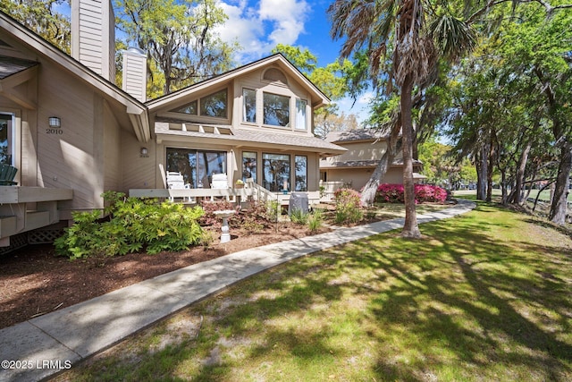 2009 Bluff Villas Rd, Saint Helena Island, SC 29920 - view of front of house featuring a chimney and a front yard