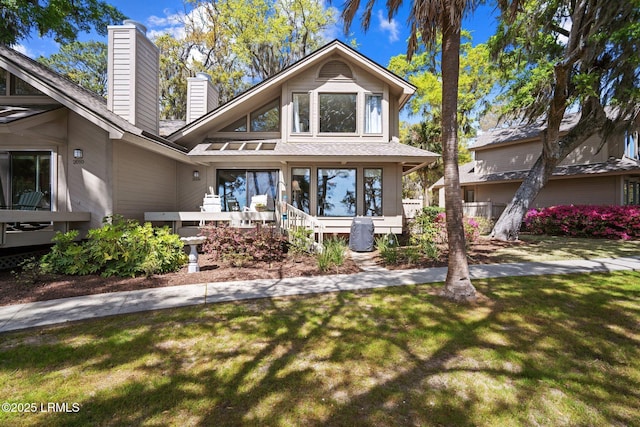 2009 Bluff Villas Rd, Saint Helena Island, SC 29920 - view of front of home with a chimney and a front lawn