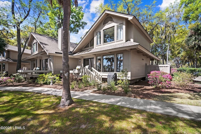2009 Bluff Villas Rd, Saint Helena Island, SC 29920 - view of front of home with a front lawn, roof with shingles, and a chimney