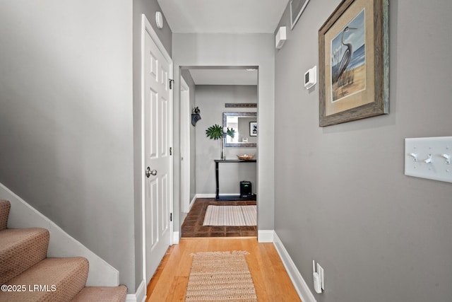 2009 Bluff Villas Rd, Saint Helena Island, SC 29920 - hall with light wood-type flooring, stairs, and baseboards
