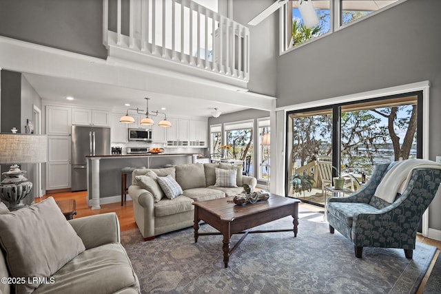 2009 Bluff Villas Rd, Saint Helena Island, SC 29920 - living area with light wood finished floors, a high ceiling, and recessed lighting