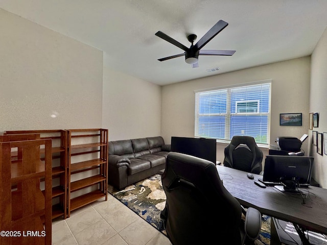 office area featuring light tile patterned floors, visible vents, and ceiling fan