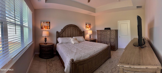 bedroom with light tile patterned floors and visible vents