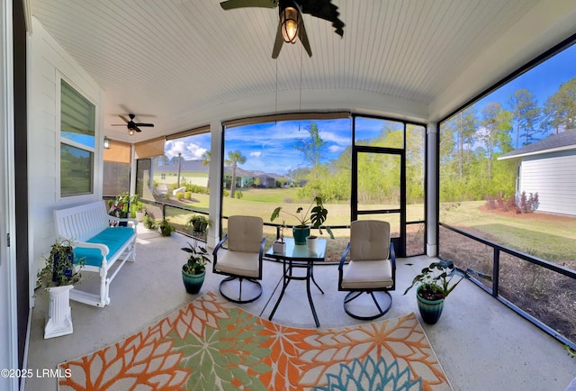 sunroom featuring a ceiling fan