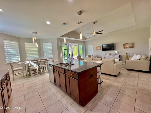 kitchen with a sink, visible vents, light tile patterned flooring, and dishwasher