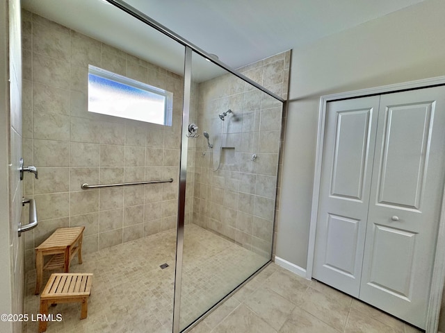 bathroom featuring a walk in shower and tile patterned flooring