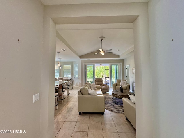 living area with light tile patterned flooring, visible vents, ceiling fan, and vaulted ceiling