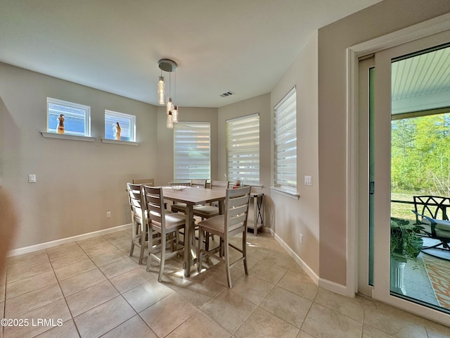 dining space with light tile patterned floors, baseboards, and visible vents