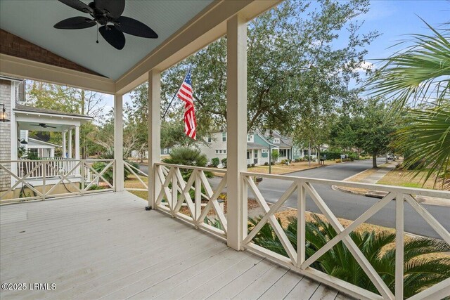 wooden terrace featuring a porch and ceiling fan