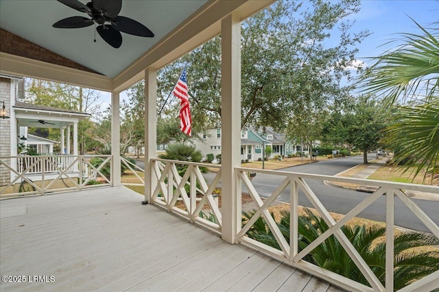 wooden terrace featuring a porch and ceiling fan