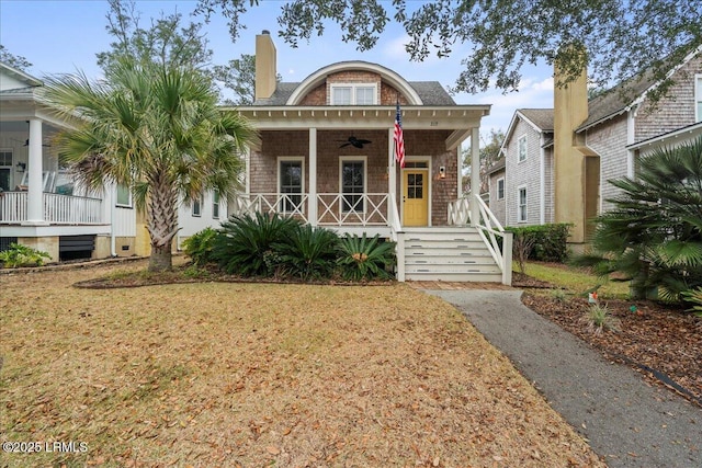 view of front of home featuring ceiling fan, a porch, and a front yard