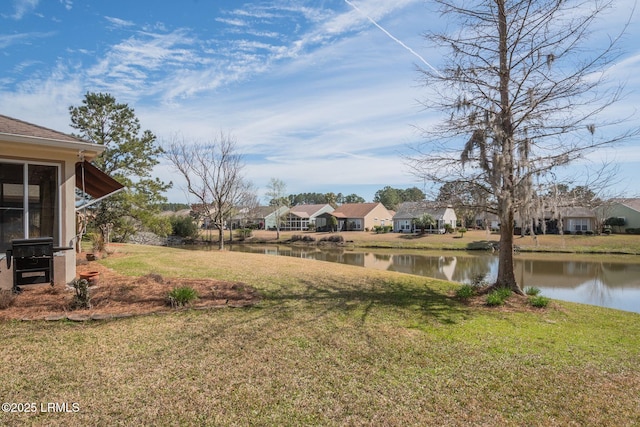 view of yard with a water view and a residential view