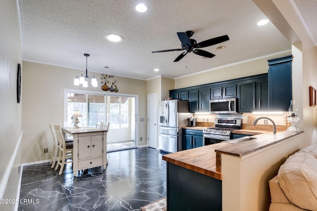 kitchen featuring ornamental molding, appliances with stainless steel finishes, a textured ceiling, marble finish floor, and butcher block counters