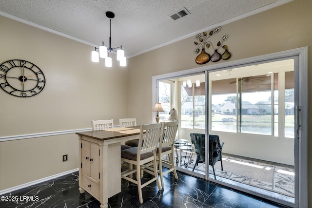 dining area featuring visible vents, plenty of natural light, a textured ceiling, and marble finish floor