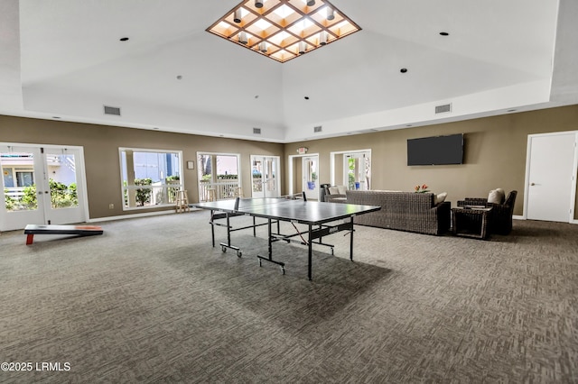 game room with carpet flooring, high vaulted ceiling, and french doors