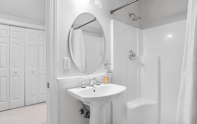 bathroom featuring walk in shower and sink