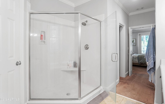 bathroom featuring a shower with door, ornamental molding, and tile patterned floors