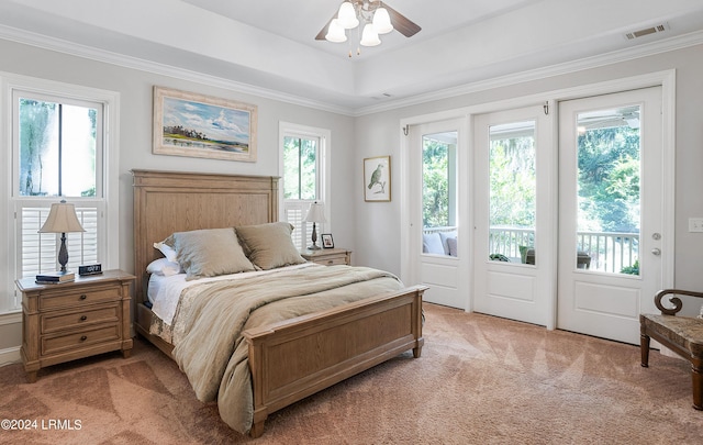 carpeted bedroom with multiple windows, access to exterior, and ceiling fan