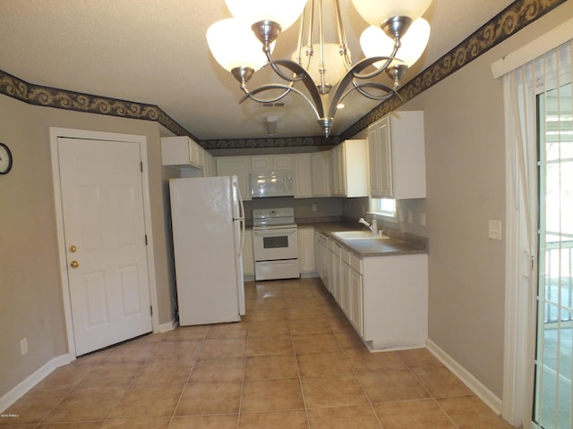 22 Ardmore Ave, Beaufort, SC 29907 - kitchen with white appliances, a chandelier, white cabinets, and light tile patterned floors