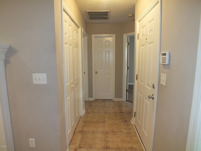 22 Ardmore Ave, Beaufort, SC 29907 - corridor featuring a textured ceiling and light tile patterned floors