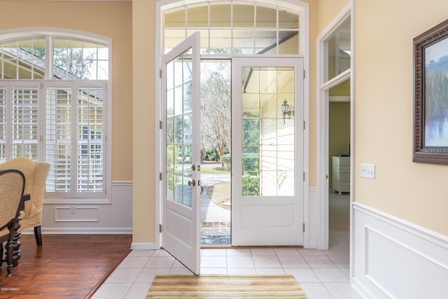 doorway to outside with light tile patterned flooring