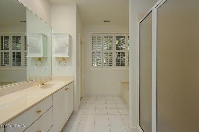 bathroom featuring tile patterned floors, plus walk in shower, and vanity