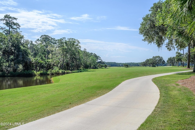 view of property's community featuring a yard and a water view