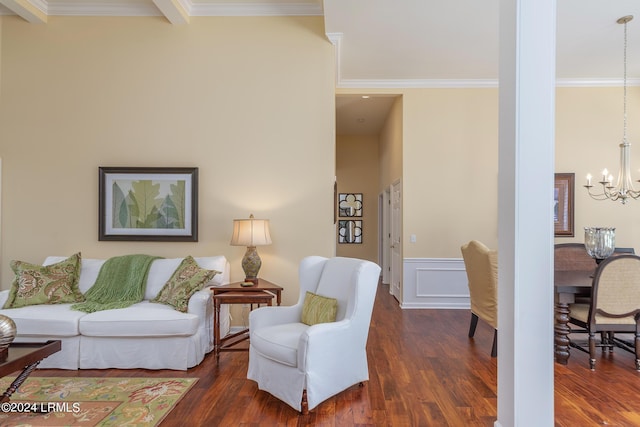 living room with an inviting chandelier, crown molding, and dark wood-type flooring