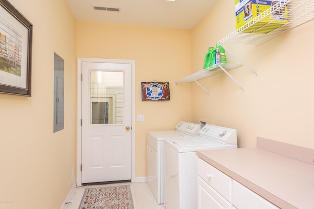 laundry area with washing machine and dryer and light tile patterned flooring