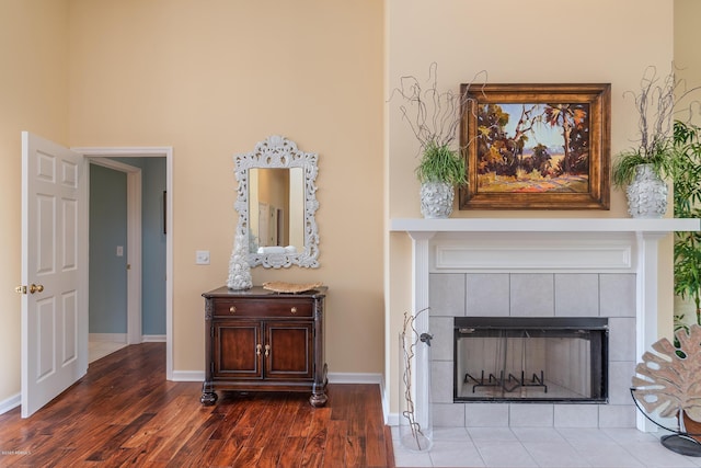 unfurnished living room featuring a fireplace and dark hardwood / wood-style flooring