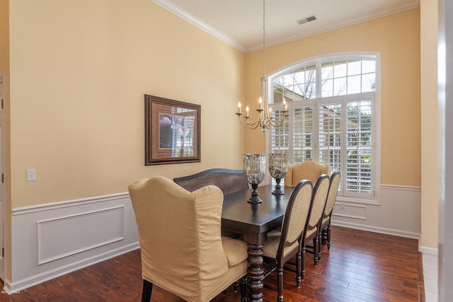 dining space featuring an inviting chandelier, ornamental molding, and dark hardwood / wood-style floors